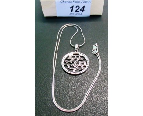 A 9ct white gold and diamond circular pierced pendant and a 9ct gold chain. Condition Report: 6 grams.