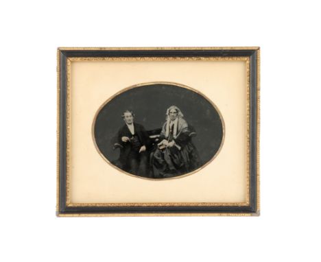 in a black &amp; gilt frame, the background has been masked black, with some gilding detail to print,