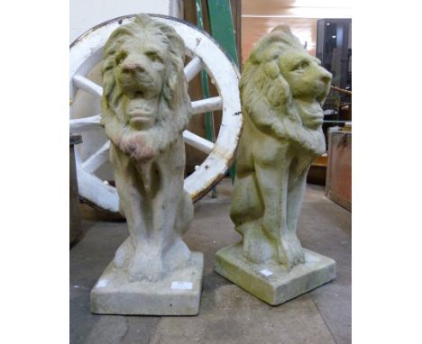 A pair of concrete garden figures of seated lions 