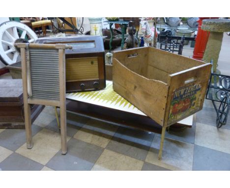 A pine apple crate, a walnut valve radio, a Formica topped coffee table and a washboard 