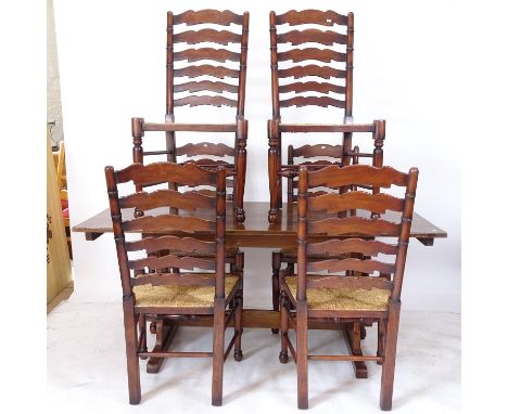 An oak rectangular refectory dining table, on pierced tablet ends, together with a set of 6 ladder-back rush-seated dining ch