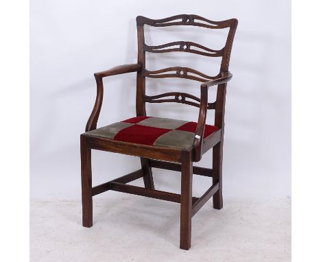 An 18th century mahogany open-arm chair, with ribbon back, in the manner of Chippendale