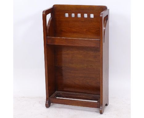 A Glasgow School Arts and Crafts walnut umbrella/stick stand, with square cut-outs to the back