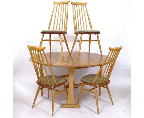 An Ercol 610 light elm drop leaf dining table on beech legs, together with a set of 4 matching Ercol stick-back chairs 