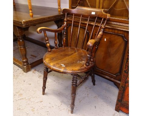 A Victorian stick-back elm-seated kitchen elbow chair 