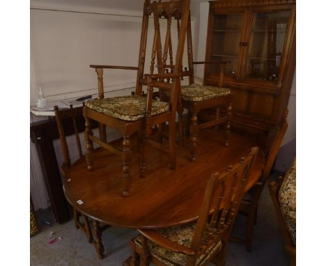 An Ercol elm lounge and dining room suite, comprising an oval table with 8 matching elbow chairs, 2 2-section wall units, and