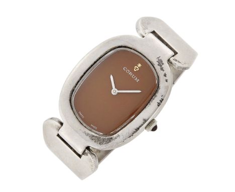 Mechanical, oval brown numberless dial, synthetic cabochon ruby crown, dial signed Corum, case back engraved 'M, Happy 8.18.7