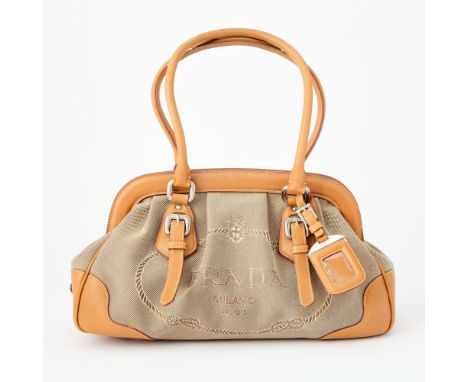 Beige canvas with brown leather trim and dual top handles, silver-tone hardware, signed Prada. Some wear to leather. Tarnishi