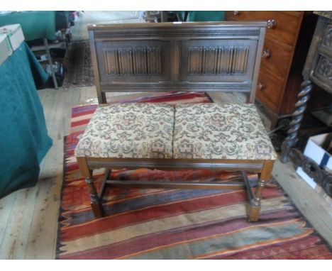 A reproduction oak two seater bench, 87cm wide.