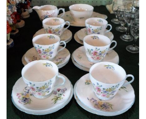 An early 20th century Shelley bone china part-tea service, in the Wild Flowers pattern, numbered 13668, comprising six trios,