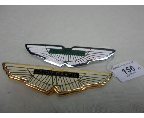 An Aston Martin chrome and enamel nose badge, 12cm, together with a further gilt metal and enamel Aston Martin nose badge, 12