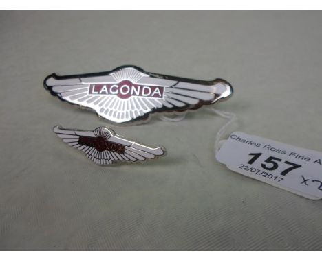 An Aston Martin Lagonda chrome and enamel nose badge, 10cm, together with an Aston Martin wheel trim badge, 5cm.