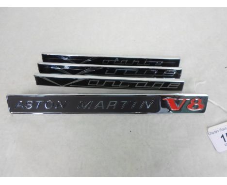 A chrome and enamel Aston Martin V8 side badge, 21.5cm, together with three further Aston Martin side badges for the Vantage,