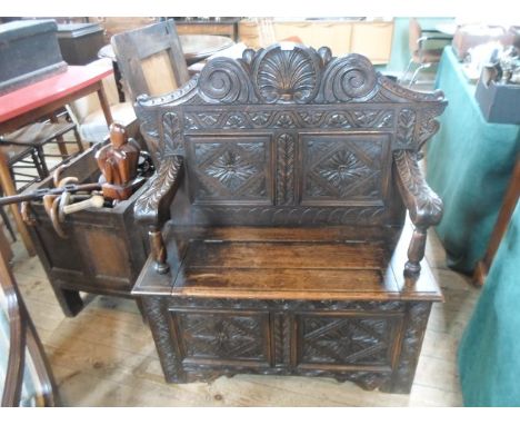 A carved oak monk's bench, 102cm wide.