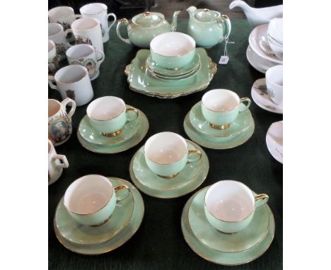 A Paragon china part-tea service, a five place setting, comprising trios, teapot, square sandwich plate and other items.