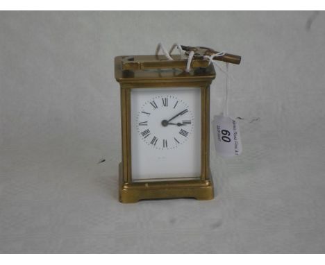 A French gilt brass carriage clock, having five bevelled edge glass panels, the enamel dial bearing Roman numerals, 14cm, han