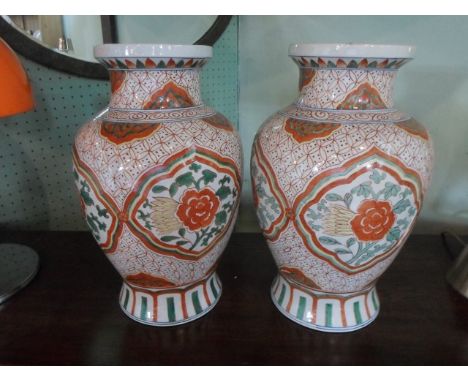 A pair of contemporary Chinese vases, decorated in polychrome enamel on an ivory ground, 40cm.