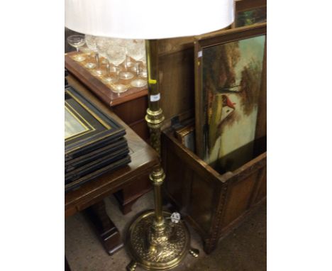 An Art Nouveau style brass embossed standard lamp and shade 