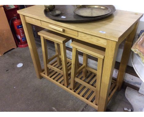 A light oak breakfast table with two stools