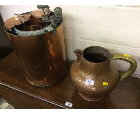 A copper and brass jug; and a copper gin still 