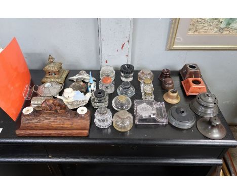 A large collection of inkwells, including pewter, ceramic, wooden, brass and glass examples 