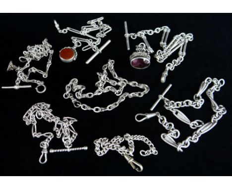 SEVEN SILVER WATCH CHAINS of various design one with revolving bloodstone and carnelian fob, another with amethyst, various d
