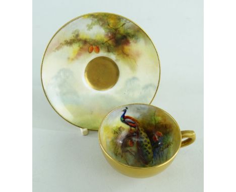 ROYAL WORCESTER MINIATURE CUP & SAUCER painted by H. W. MARTIN with peacock overall gilded, printed puce marks to base date c