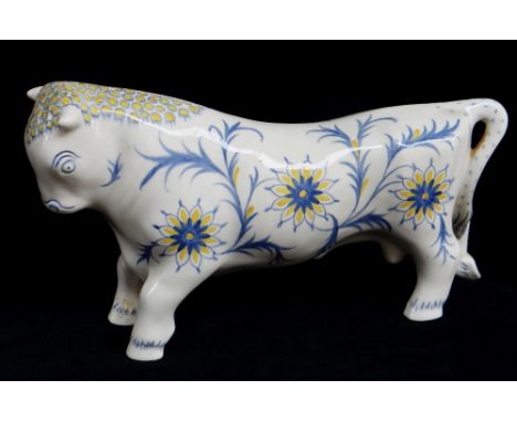 ARNOLD MACHIN FOR WEDGWOOD: Queensware model of 'Ferdinand the bull', c. 1941, painted blue and yellow floral decoration, pri