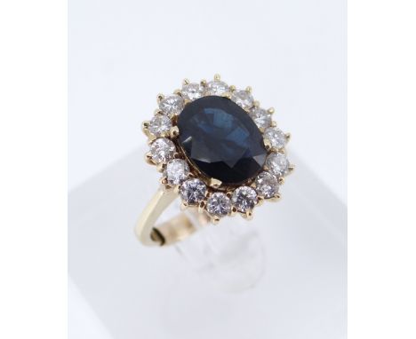 YELLOW METAL SAPPHIRE & DIAMOND CLUSTER RING, the central sapphire 9 x 7mms surrounded by fourteen diamonds, ring size K, 5.3