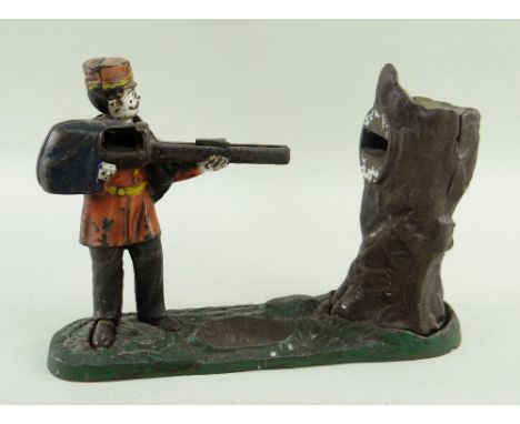 MECHANICAL CAST IRON 'GRENADIER BANK', painted details, 25cms longThe money bank is not in working order.The firing mechanism