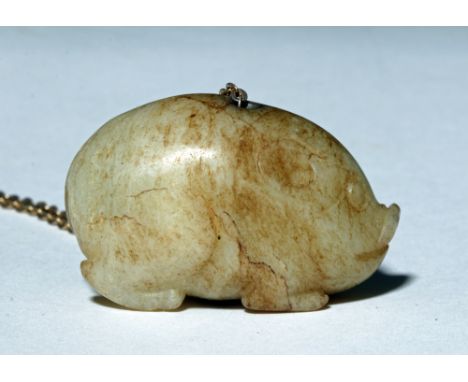 China, Qing Dynasty, ca. early 1800s CE. This is a small jade carving of a pig sitting on its curved legs. Size: 1.5" L x .5"