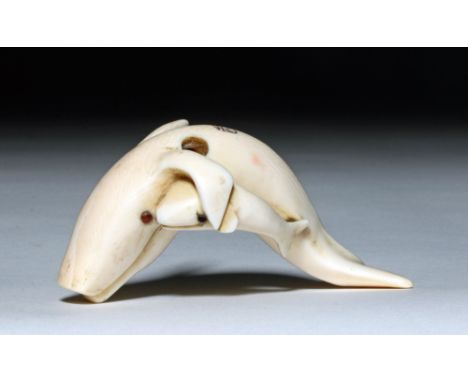 Japan, early 20th century CE.  A rare and touching ivory netsuke depicting a whale mother and her calf. Showing fluid motion 