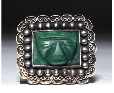 Mexico, ca. 1940 CE.  Beautiful silver and jade brooch.  Jade maskette in the form of a Teotihuacan lord adorns the center wi
