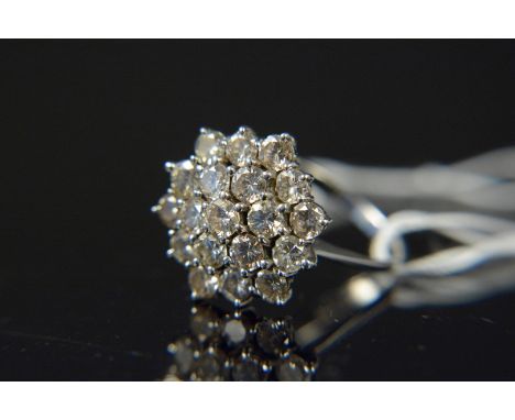 An impressive 18ct white gold diamond floral cluster ring, the nineteen brilliant cut diamonds in tiered setting, size N 1/2,