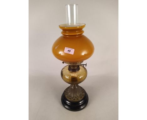 A Victorian brass oil lamp with pale amber glass reservoir
