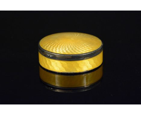 A silver circular trinket box with yellow guilloche enamel decoration to lid and main body, makers mark H H &amp; Co