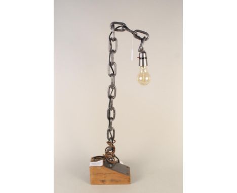 An unusual welded chain table lamp mounted on a wooden block, 74cm tall