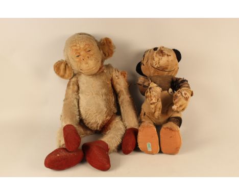 An early c1920's/30's blond mohair monkey with articulated arms and legs, straw stuffed and painted face, 67cm long (some los