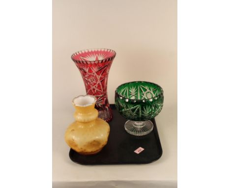 A large Bohemian glass cranberry to clear vase, 31 1/2cm high plus a green to clear footed bowl and an amber coloured vase