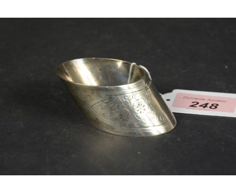 A silver napkin ring of slanted shape with engraved floral decoration, hallmarked Sheffield 1896, maker Roberts &amp; Belk, w