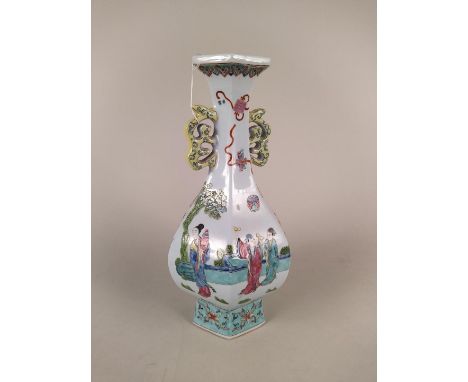 A 20th Century Chinese hexagonal shaped baluster vase with applied stylised dragons to the neck and figures in a garden setti