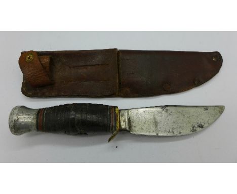 A WWI knife with leather scabbard