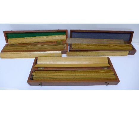 Three wooden boxes containing twenty-seven scale wooden rulers