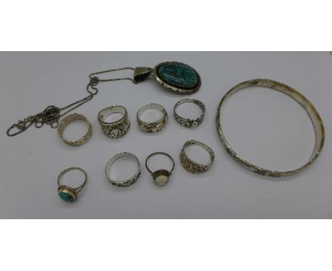 Eight silver and white metal rings, a sterling .925 silver bangle and a sterling and turquoise pendant, 62.9g
