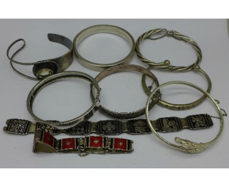 Six silver bangles and two silver bracelets, 140g, and one metal bangle