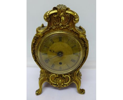 A Louis XV style gilt mantel clock with engine turned Roman dial