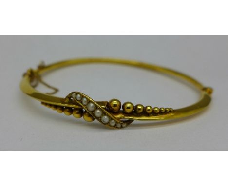 A yellow metal and seed pearl set bangle, 4.8g