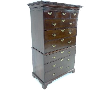 A George III mahogany tallboy, chest on chest, the pediment with dentil moulding, two short, one medium and five long drawers