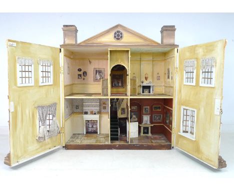 A large and impressive Queen Anne style doll's house, hand made and painted, the pediment above with two opposing chimneys, t