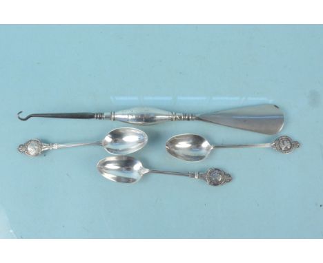 An unusual silver handled shoe horn and button hook together with three silver Royal commemorative spoons